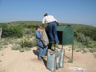 manuel-and-willie-emptying-deer-feed-bag.jpg